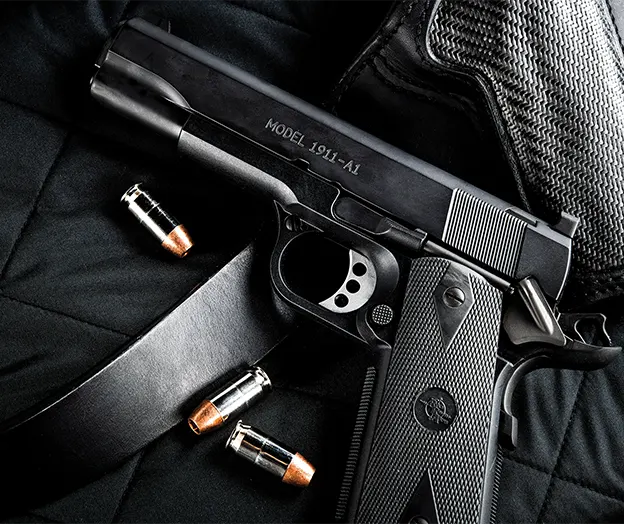 Firearm & Holster Lying on bed with Rounds of Ammunition